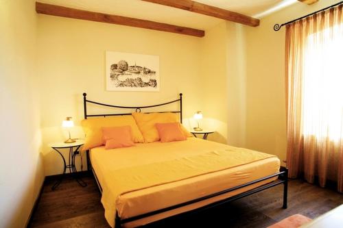 a bedroom with a large bed with two tables at Villa Simone in Žbandaj