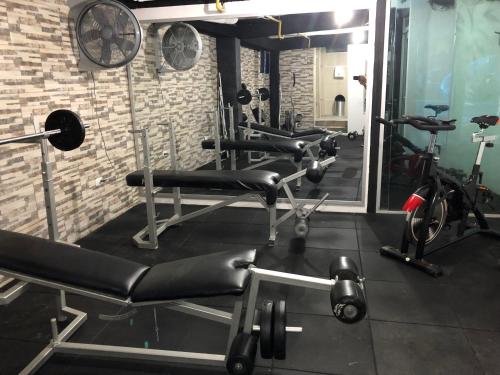 a gym with several exercise bikes and a mirror at Hotel La Cascada - Lago Agrio in Nueva Loja