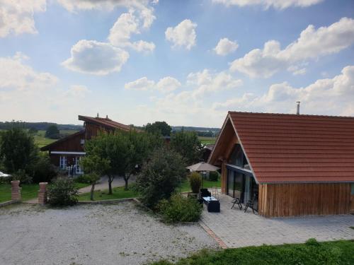 a house with a red roof and a courtyard at 1Austragshaus Andermichlhof in Geltendorf