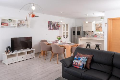 a living room with a couch and a dining room table at ISLAND HVAR LUXE Holiday Villa Maslina with Beach in Milna