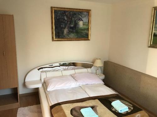 a bedroom with two beds and a painting on the wall at Gospodarstwo Agroturystyczno-Edukacyjne Gratka in Celiny