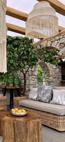 a living room with a couch and a table at Byblos Luxury Villa in Prinos