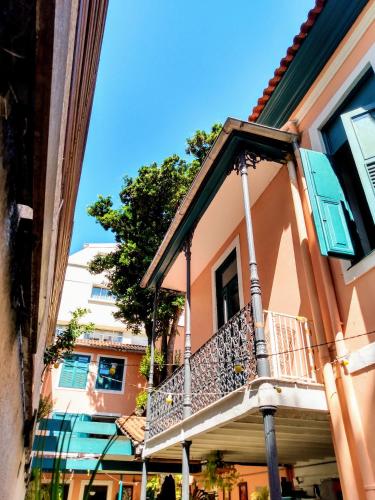 a balcony on a building with a tree in the background at Hospedaria Rio in Rio de Janeiro