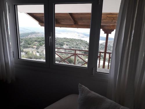 a room with a window with a view of a mountain at Ionian Balcony - Davgata in Dhavgáta