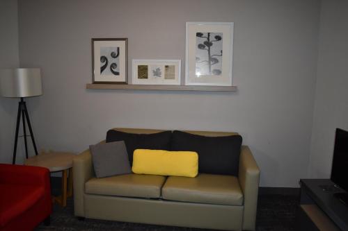 a living room with a couch with a yellow pillow at Country Inn & Suites by Radisson, Hagerstown, MD in Hagerstown