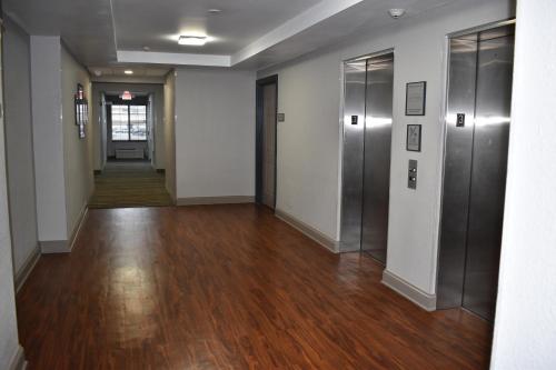 an empty hallway with wood floors and elevators at Country Inn & Suites by Radisson, Hagerstown, MD in Hagerstown