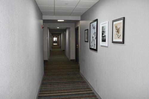 a hallway with pictures on the walls of a office at Country Inn & Suites by Radisson, Hagerstown, MD in Hagerstown