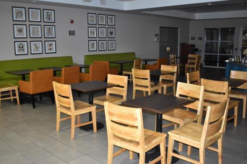 a dining room with wooden tables and chairs at Country Inn & Suites by Radisson, Hagerstown, MD in Hagerstown