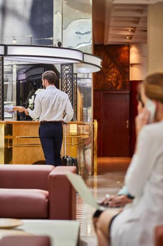 a man standing behind a bar in a restaurant at Silken Ciudad de Vitoria in Vitoria-Gasteiz