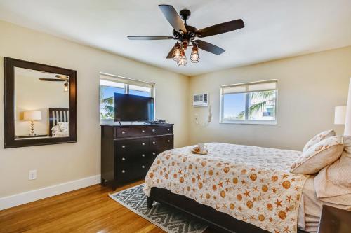 a bedroom with a bed and a ceiling fan at Turtle Beach Retreat in Layton