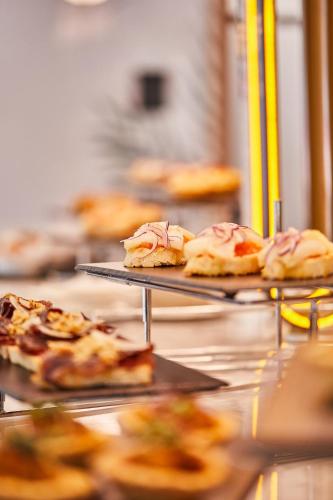 a bunch of food on trays on a table at Silken Ciudad de Vitoria in Vitoria-Gasteiz