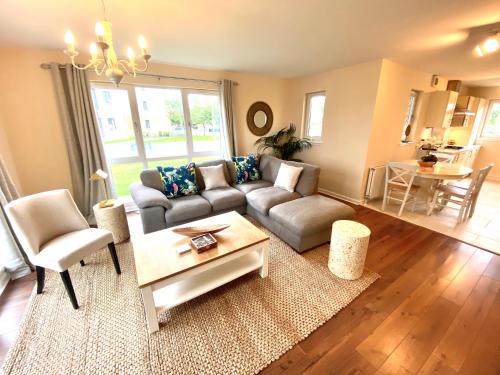 a living room with a couch and a table at Monart Stylish City Centre Apartment, 2 Bed, sleeps 6 in Perth