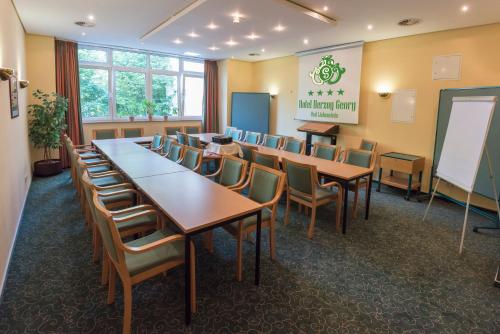a conference room with tables and chairs and a whiteboard at Hotel Herzog Georg in Bad Liebenstein
