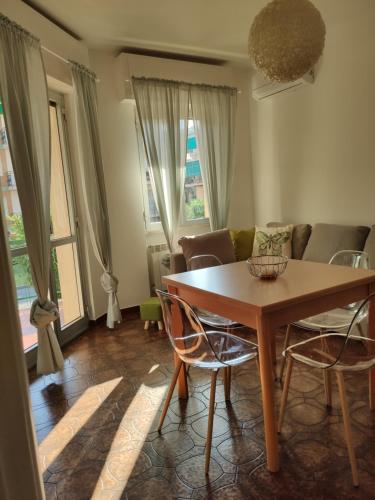 a living room with a wooden table and chairs at Verdolina - By Ligooria in Pietra Ligure