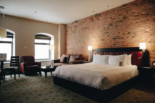 a hotel room with a bed and a fireplace at Hotel Place D'Armes in Montreal