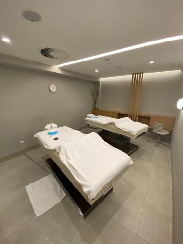 a hospital room with three beds in it at Apartman Bozur in Vrnjačka Banja