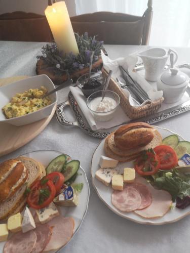 a table with plates of food on a table at Dom wczasowy Rychertówka in Grzebieniec