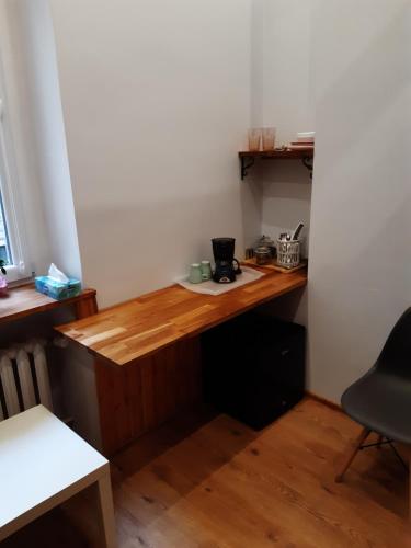 a wooden desk in a corner of a room at Kamienica Bydgoska 2 in Bydgoszcz