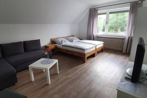 a living room with a couch and a table at Ferienwohnung auf dem Dorf in Waldfeucht