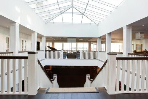 a large room with white columns and a skylight at Støtvig Hotel in Moss