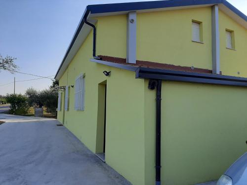 a yellow building with a door on the side of it at B&B La Casa di Paolo in Orsogna