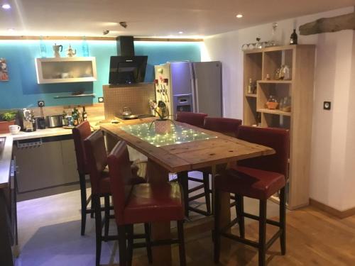 a kitchen with a wooden table and some chairs at Amazing View appartement du Chalet in Les Houches