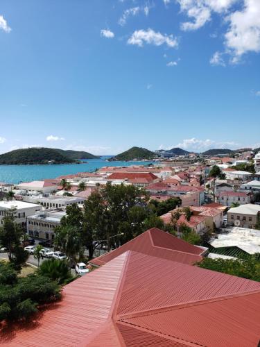 a view of a town with a red roof at Galleon House Hotel in Charlotte Amalie