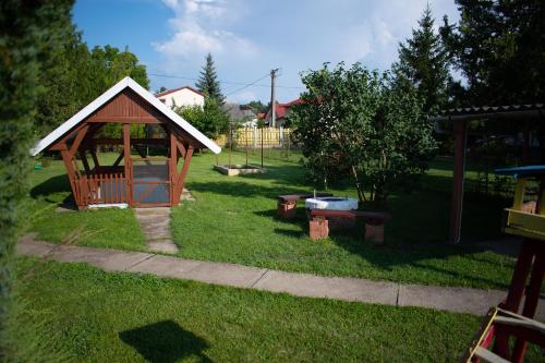 a small gazebo in a yard with a playground at Günter Vendégház-Hajdúnánás in Hajdúnánás