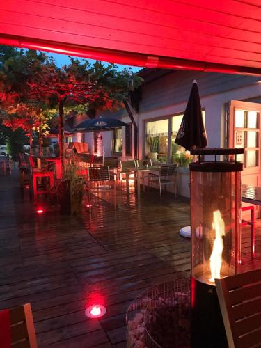 a patio with a fire pit and tables and chairs at Hotel Am Kamin in Kaufbeuren