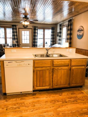 a kitchen with a sink and a dishwasher at Riverfront Mountain Cottage Retreat in Estes Park