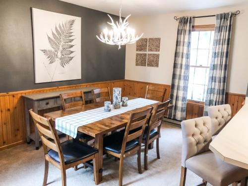 a dining room with a table and chairs at Riverfront Mountain Cottage Retreat in Estes Park