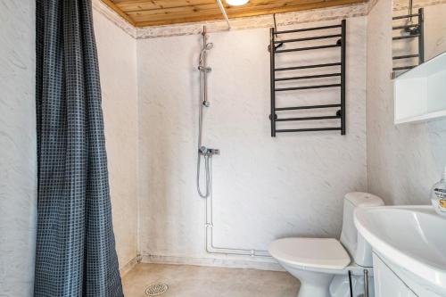 a bathroom with a shower with a toilet and a sink at Lake cottage near Isaberg in Åsenhöga