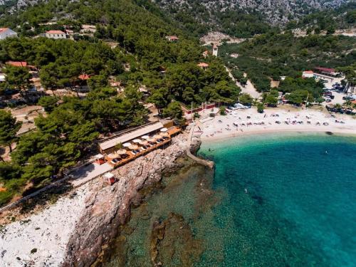 an aerial view of a beach with people and the ocean at ISLAND HVAR LUXE Holiday Villa Maslina with Beach in Milna