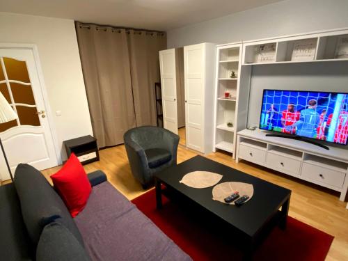 a living room with a couch and a flat screen tv at Vilnius central studio apartment in Vilnius