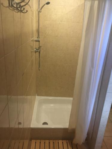 a shower with a white tub in a bathroom at Chata Ostrá Ostravice in Ostravice