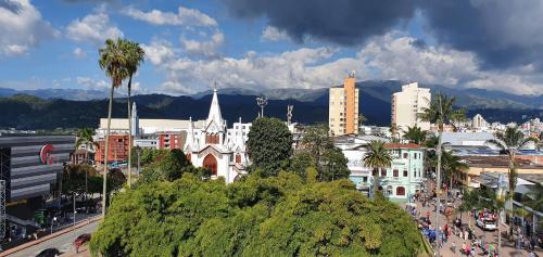 a city with a bunch of buildings and palm trees at Hotel Dubai in Manizales