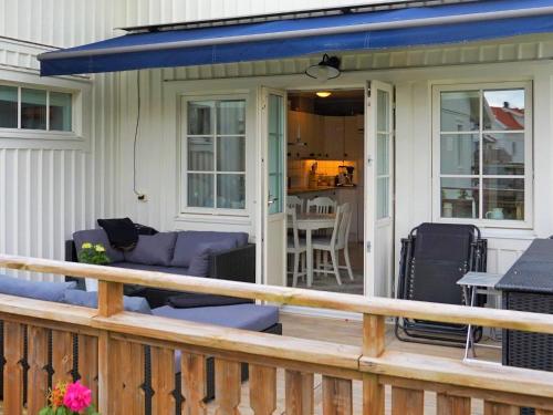 a porch of a house with a blue roof at Seaside Serenity in Mollosund-By Traum in Mollösund