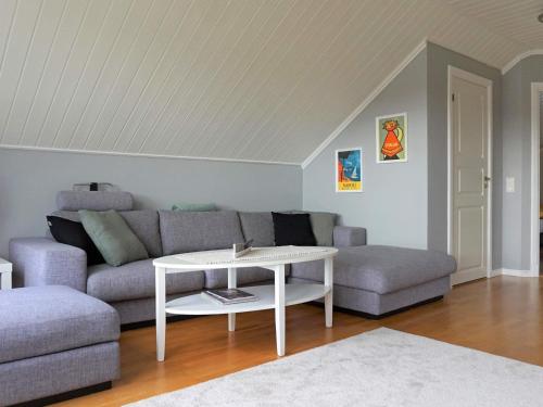 a living room with a couch and a table at Seaside Serenity in Mollosund-By Traum in Mollösund