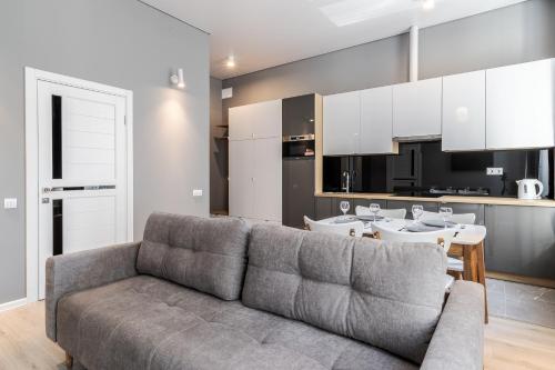 a living room with a couch and a kitchen at InshiApartments on Popovycha str 2 in Lviv