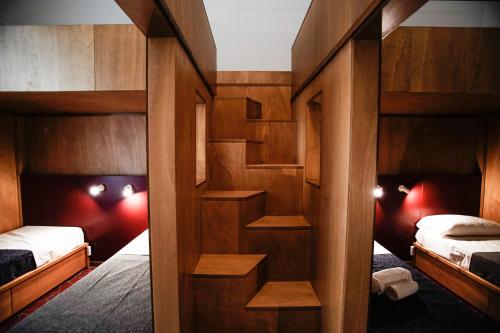 a room with two beds and two bunk beds at NAP Hostel Spaccanapoli in Naples