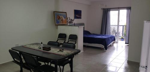 um quarto com uma mesa, cadeiras e uma cama em Departamento Santo Tome centrico em Santo Tomé