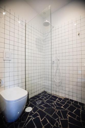 a bathroom with a toilet and a shower at NAP Hostel Spaccanapoli in Naples