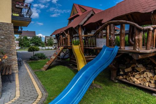 a playground at a resort with a slide at Dunajecki Dworek in Zakopane