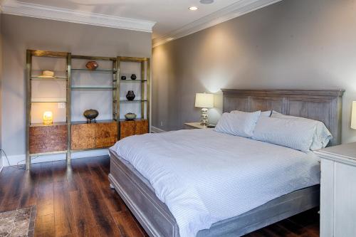 a bedroom with a large bed with a wooden headboard at Liberty Street Redbrick Town and Carriage House in Savannah