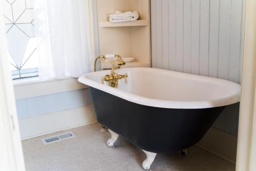a black and white bath tub in a bathroom at The Mulberry Inn -An Historic Bed and Breakfast in St. George