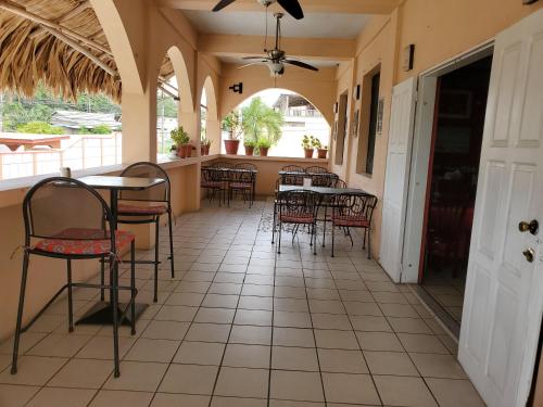 a patio with tables and chairs in a restaurant at Rolson Hotel in San Ignacio