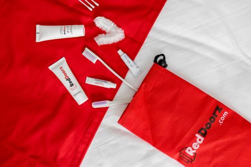 a red dress with a pair of scissors and other items at Artayya Puri Homestay near Terminal Purabaya Madiun Mitra RedDoorz in Madiun