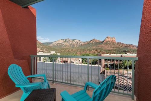 a balcony with two chairs and mountains in the background at Matterhorn Inn in Sedona