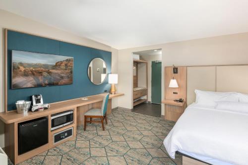 a hotel room with a bed and a desk at Matterhorn Inn in Sedona