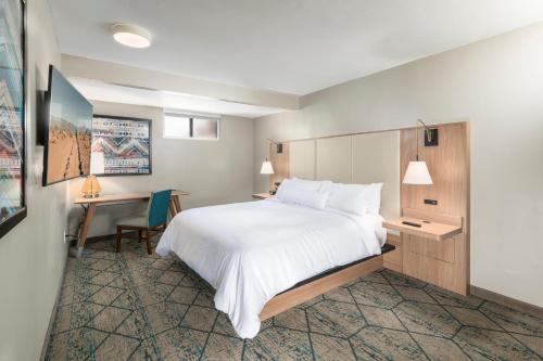 a hotel room with a bed and a desk at Matterhorn Inn in Sedona